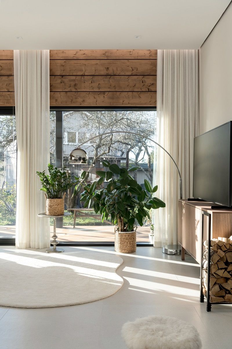 Indirect LED lighting in a curtain recess above the large windows in the living room